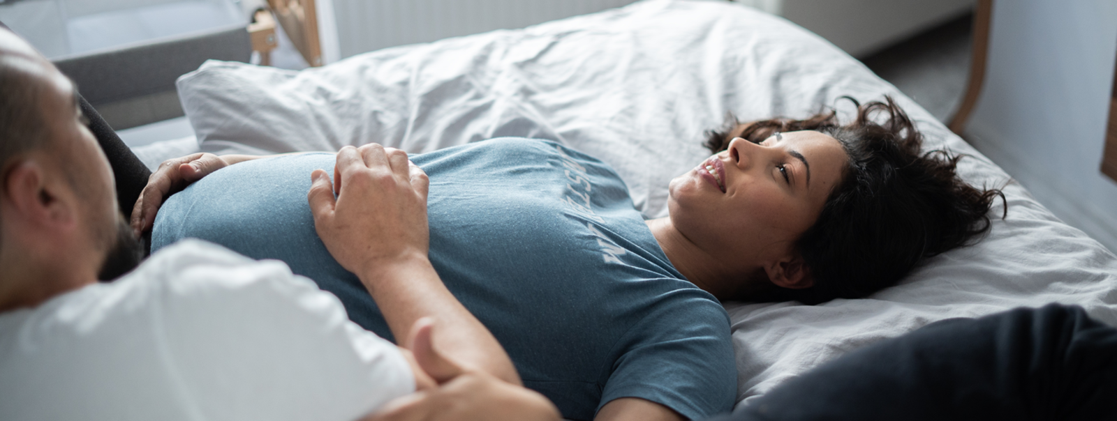 Pregnant woman reading a book in a library.