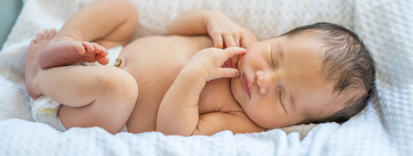 Baby laying on bed
