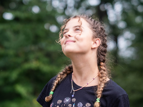 Young lady smiling up at the sky