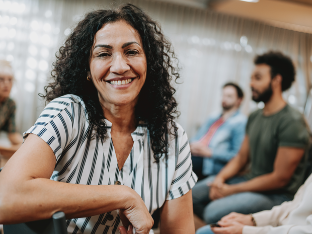Latino woman sitting with friends