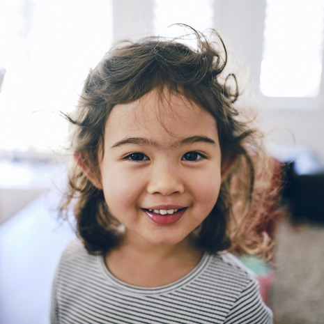 young girl smiling inside