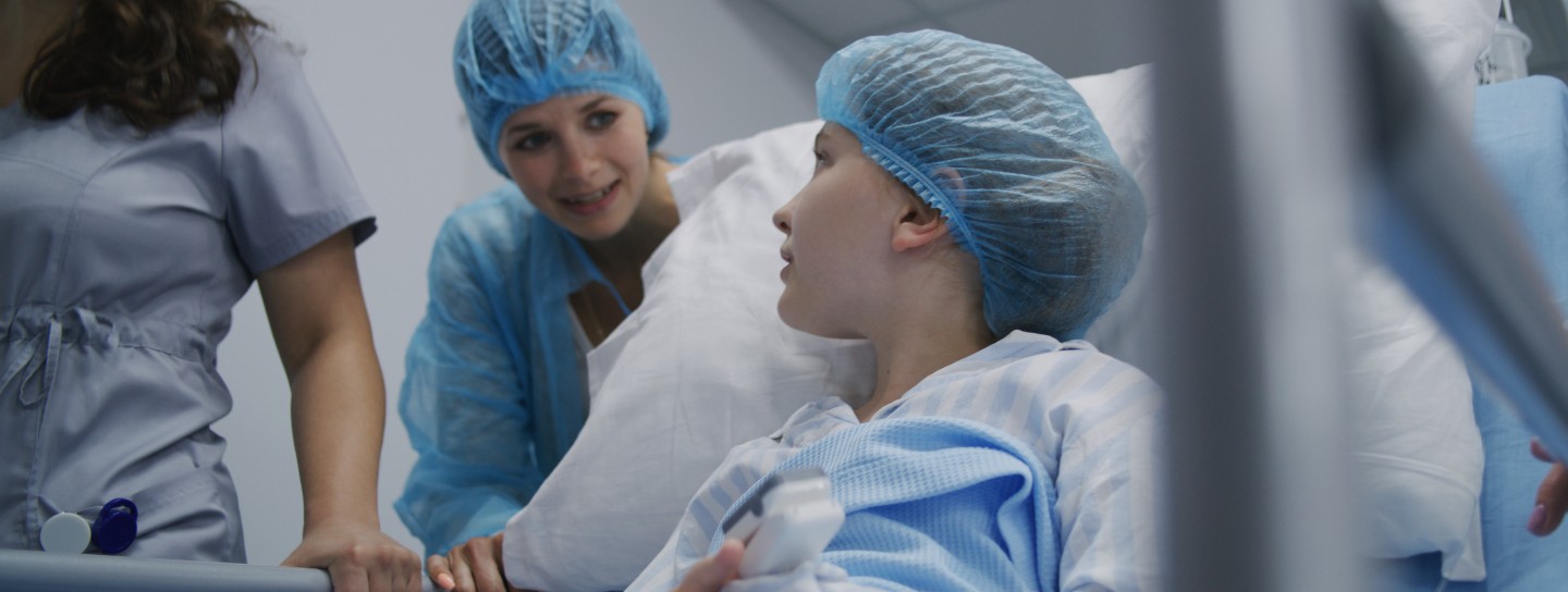 Medics transport young patient to hospital room after surgery