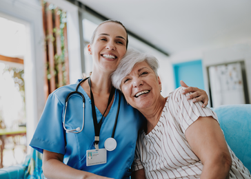 A nurse smiles with an older patient