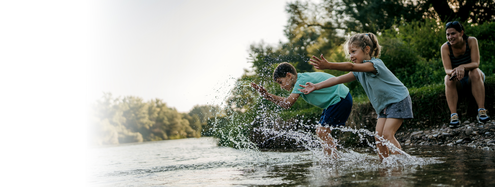 Woman putting a hat on her son.