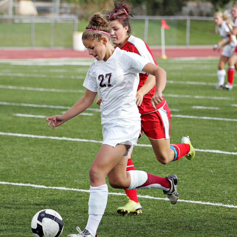 Teenage girl playing soccer