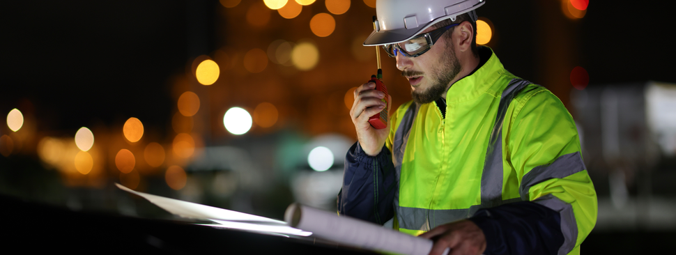  Electrical engineer uses a walkie-talkie at night