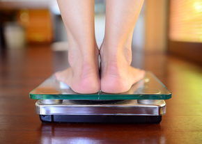 A person stands on a scale