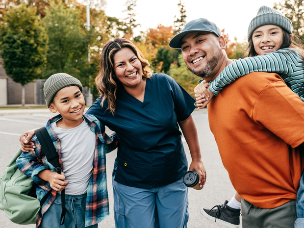 Family smiles outside