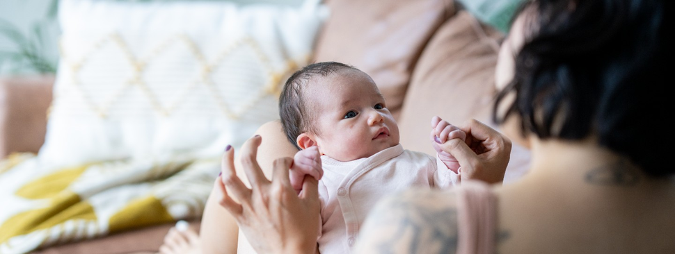 mother playing with new born child