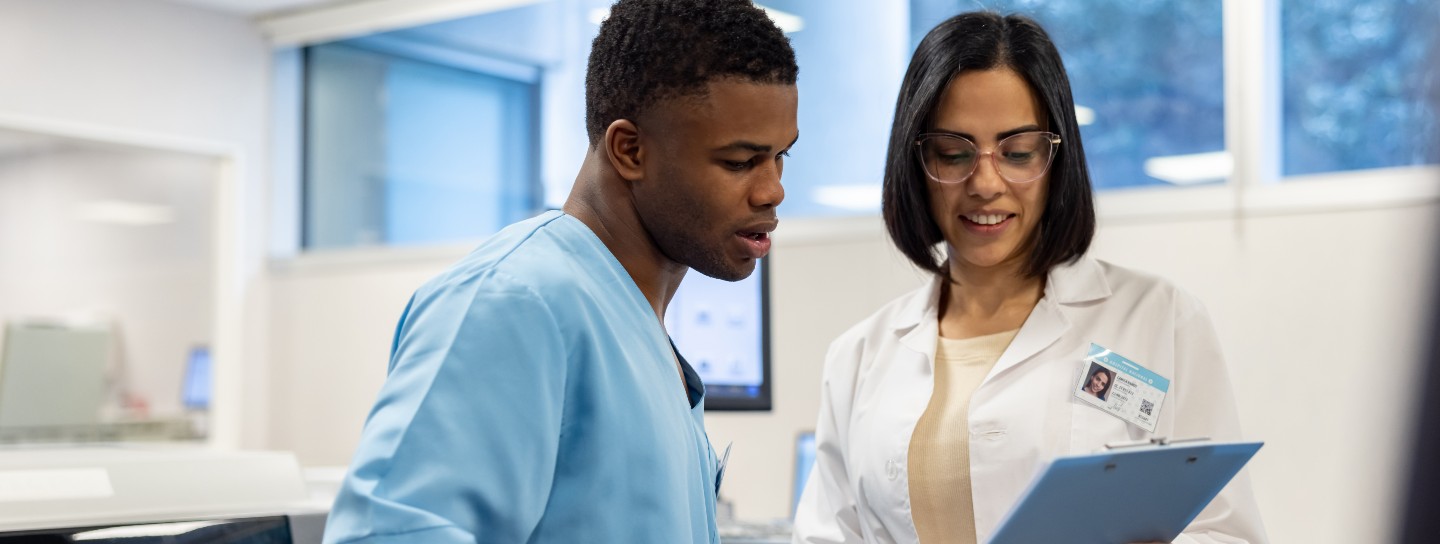 Doctor and lab technician discuss research results