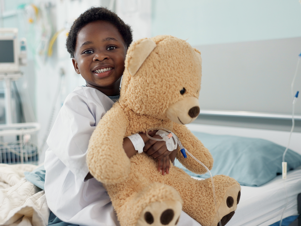 Child hugs teddy bear at the hospital
