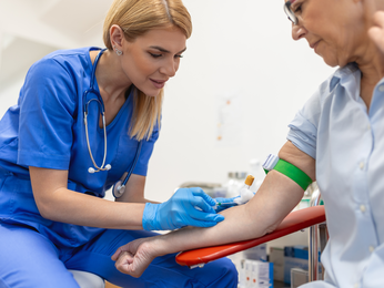 Provider with scrubs on injects needle into clinical participant.