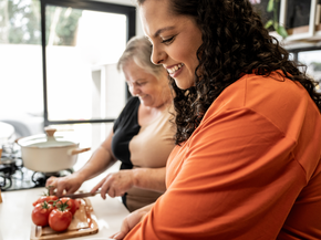 Mother and daughter cooking together