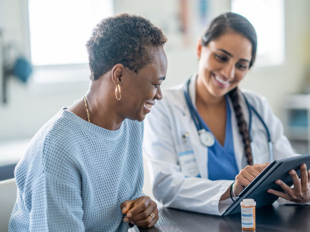 Woman meets with her doctor as they review her medications together.