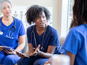 Diverse medical staff meeting in hospital to discuss nursing program