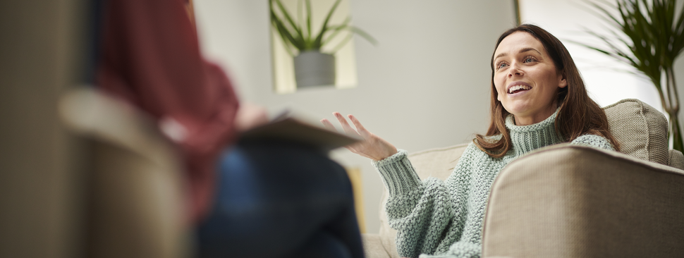 Woman talks to therapist on couch