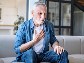 older man with hand on his chest