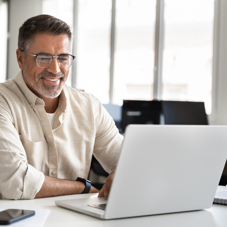 Mature man using a laptop in a professional setting