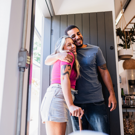 woman with a cane is greeted by a friend