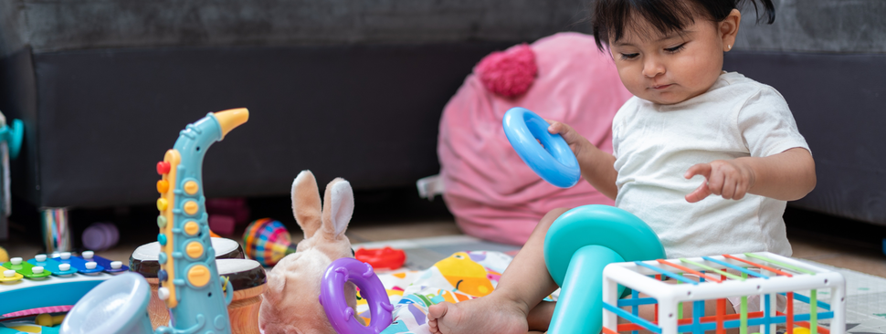 Toddler playing with toys in the living room