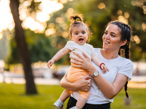 Woman plays with baby outside