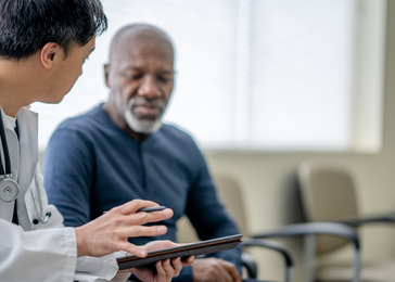 Man speaks with provider in hospital.