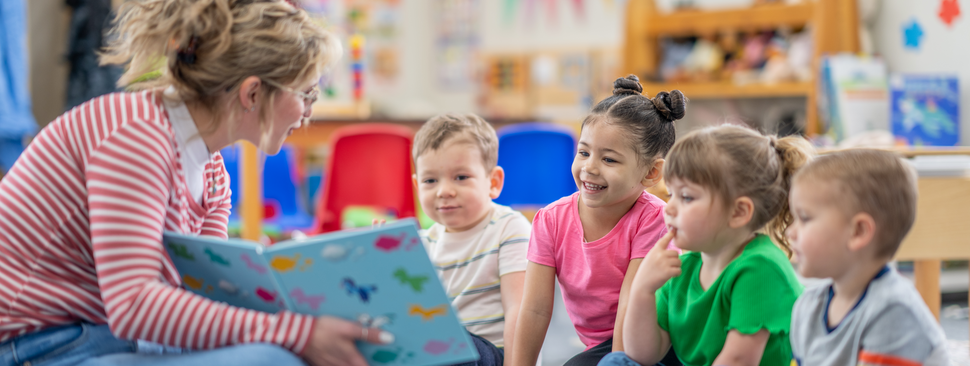 Teacher reading book to kids