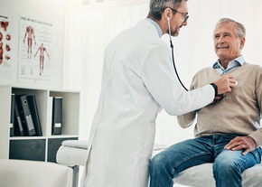 A doctor checks the heart rate of a patient
