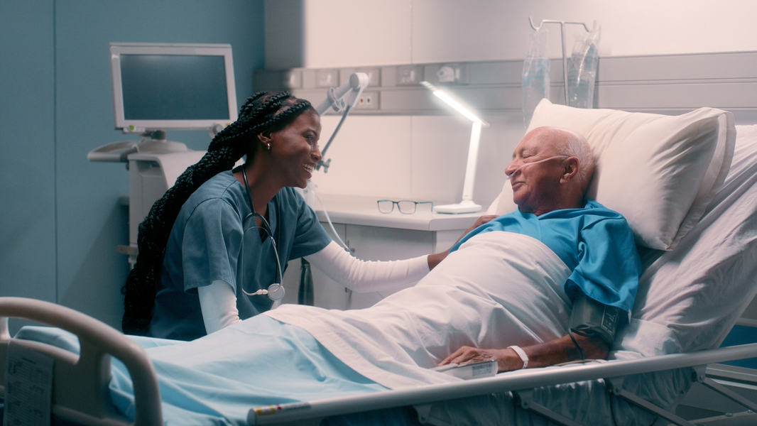 Nurse caring for senior male patient