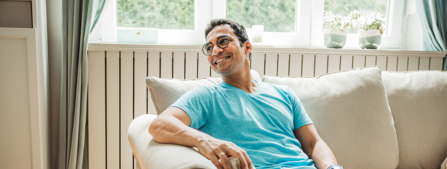 Man sitting on sofa smiling