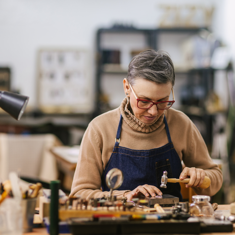 a woman makes jewelry