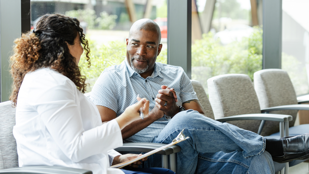 Man sitting in conversation with a provider
