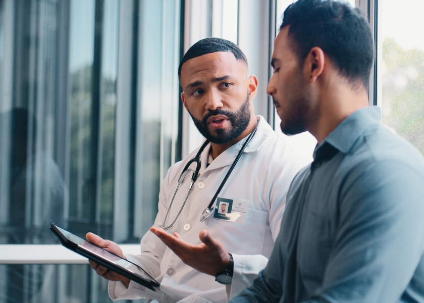 A doctor and patient sit to have a discussion