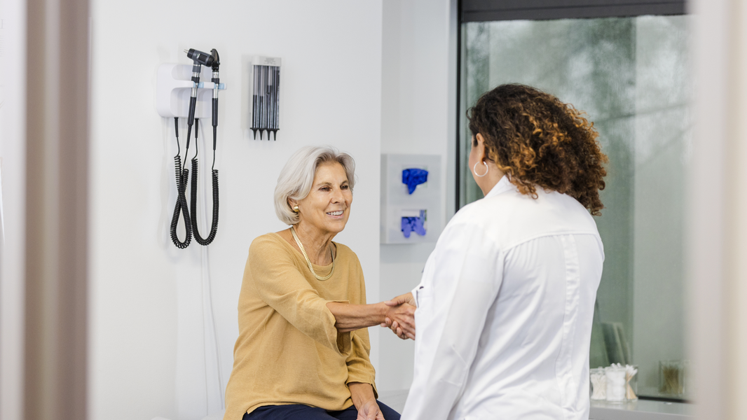 Nurse caring for senior male patient