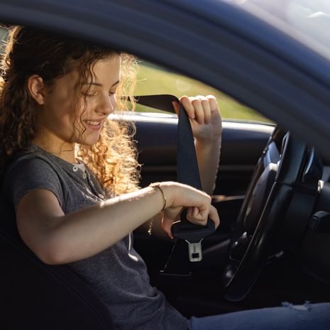 teenage girl buckling her seatbelt