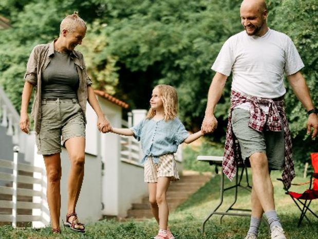 Family smiles while walking outdoors