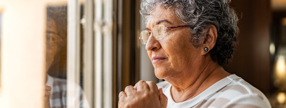 Older woman looking out a window