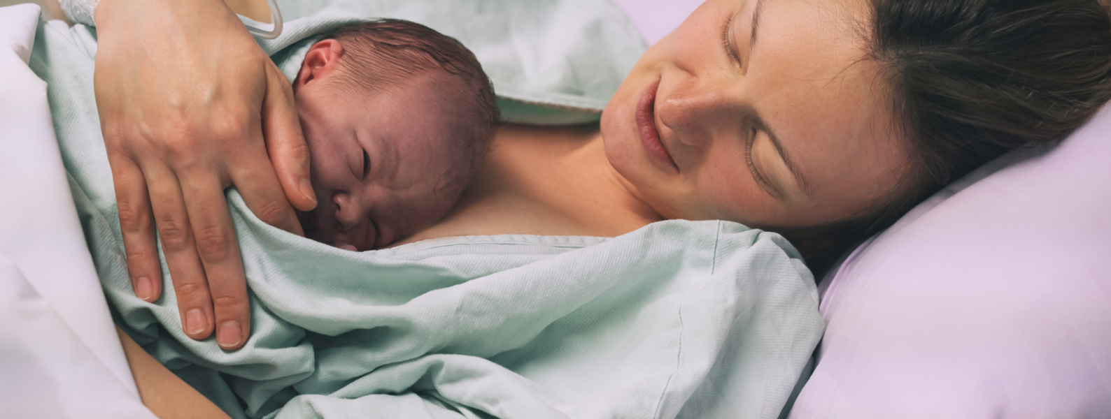 A mother spends a moment with her newborn on her chest.