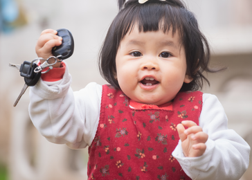 Toddler holding car keys.