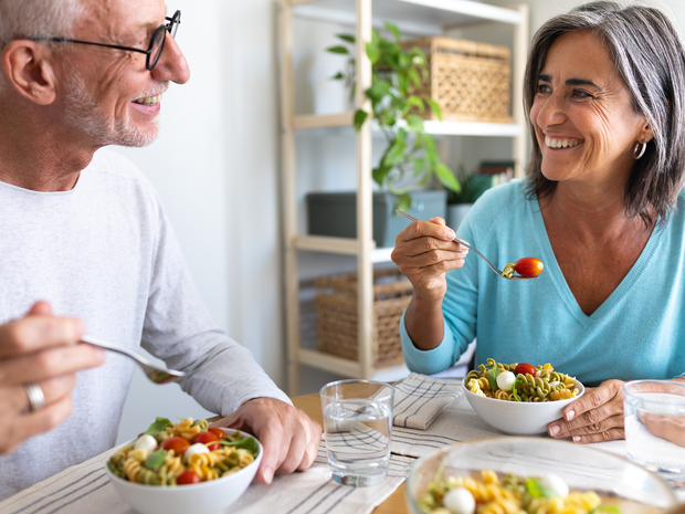 mature couple eating salads together for lunch