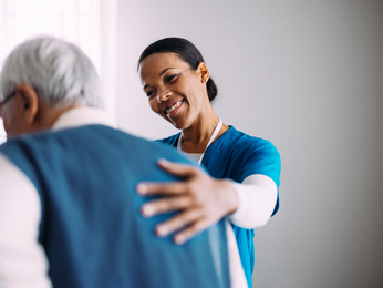 Provider holds hands with patient.