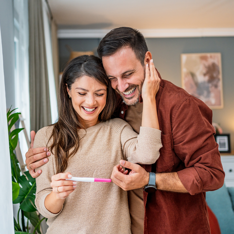 Happy couple looking at pregnancy test