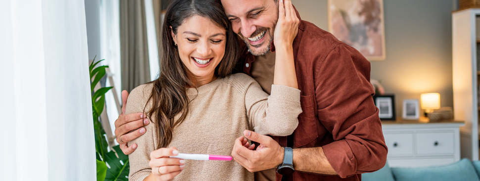 Happy couple looking at pregnancy test