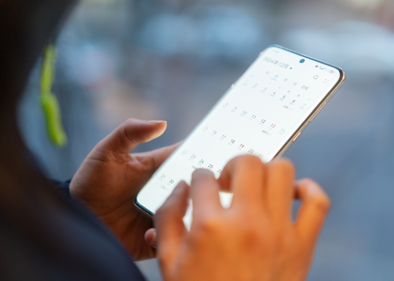 Woman on phone scheduling an appointment.
