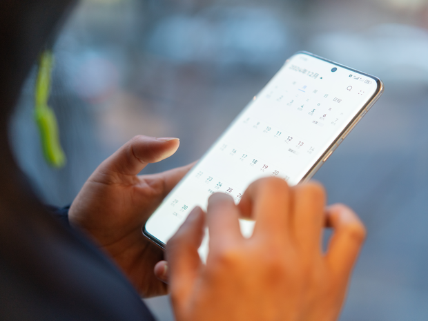 Woman on phone scheduling an appointment.