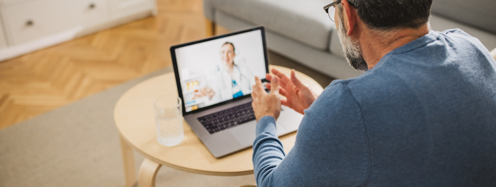 Mature man talking on video call with his doctor.