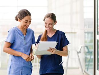 Two providers talking and smiling