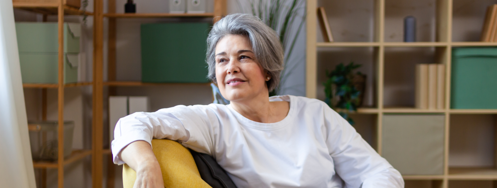 A woman sits comfortably in a chair