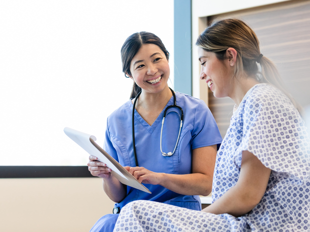 smiling nurse talking to patient