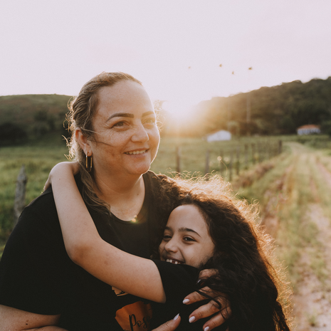 Mother and daughter hiking in woods